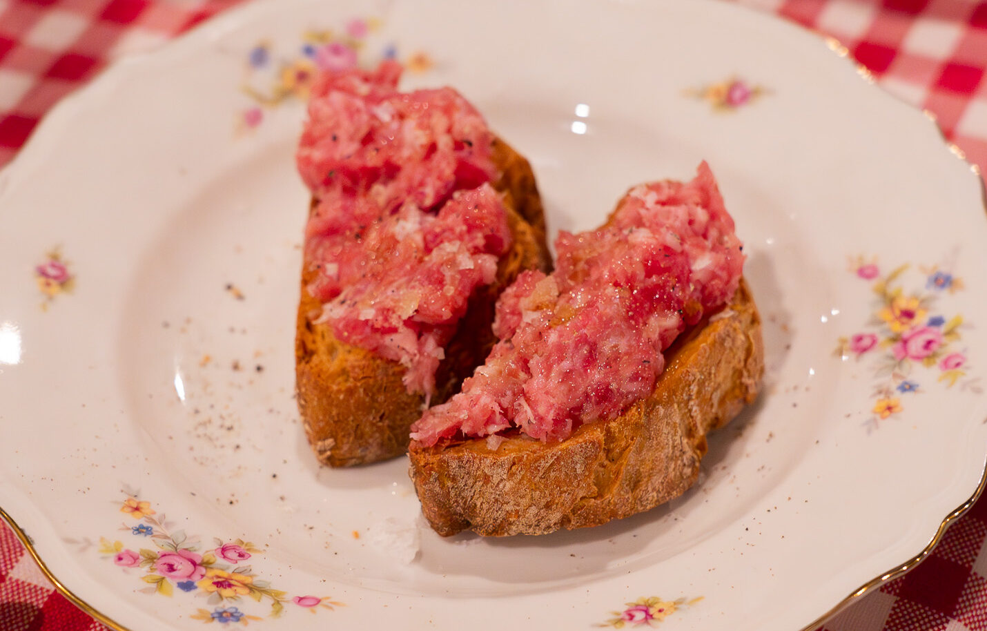 Raw Luganega sausage  with crostini bread